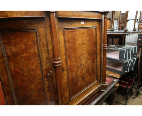 Victorian walnut side cabinet, the moulded top above a central panel door flanked by turned pilasters and further canted pane