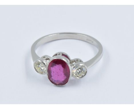 Platinum ring set central oval ruby flanked by two circular cut diamonds, size NGood overall condition. Ruby approximately 8m