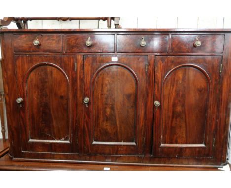 19th Century mahogany sideboard, the shallow figured top above four small frieze drawers and three arched panel doors with br