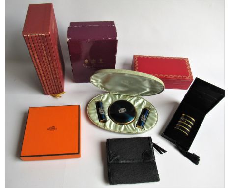 Three empty presentation boxes by Hermes, Cartier and Asprey, Louis Vuitton city guide, DKNY purse, Yves St. Laurent cigarett