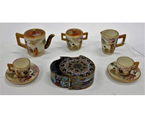 A MINIATURE JAPANESE MEIJI PERIOD SATSUMA TEASET to include two cups and saucers, a teapot, a sugar bowl and a milk jug, the 