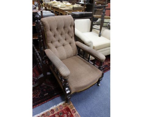 A VICTORIAN MAHOGANY FRAMED UPHOLSTERED LIBRARY CHAIR with turned supports and ceramic castors 70cm wide 