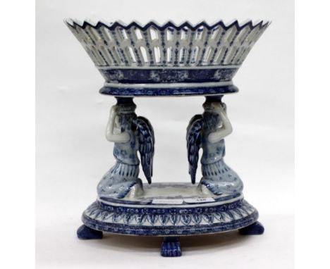 A 20TH CENTURY MIDDLE EASTERN BLUE AND WHITE CERAMIC TAZZA with basket weave bowl standing on angel base 28cm high 