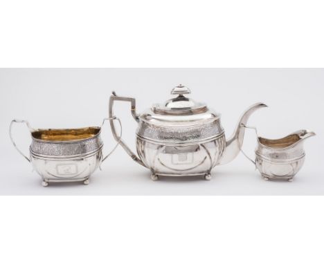 A George III silver three-piece tea service, maker Duncan Urquhart & Naphtali Hart, London, 1810: crested, of barge shaped ou