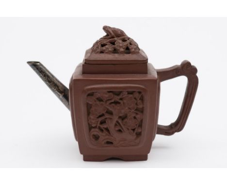 A Chinese Yixing teapot and cover: of square section moulded with panels of prunus, the reticulated cover with toad finial, r