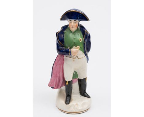 A Staffordshire portrait figure of Napoleon Bonaparte: modelled standing in military uniform wearing a tricorn hat and holdin