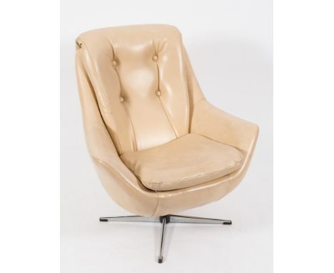 A 1960's button back swivel armchair:, upholstered in cream faux leather, having a cushion seat, on chromium cruciform base.