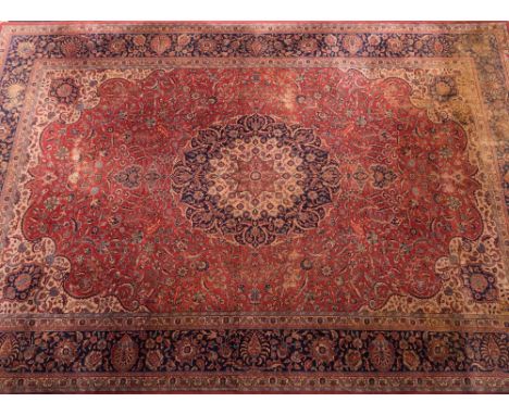 A Sivas Carpet:, the pink cartouche field with a central biege, pink and indigo flowerhead medallion and all over designs of 