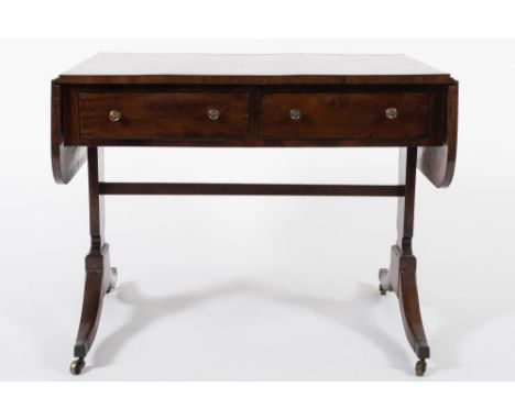 A Regency mahogany and ebony strung sofa table:, the hinged top with rounded corners, fitted with two frieze drawers on solid