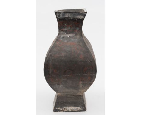 A large Chinese pottery square section baluster vase, Hu:  painted in red with an overall design of scrollwork on a dark grey