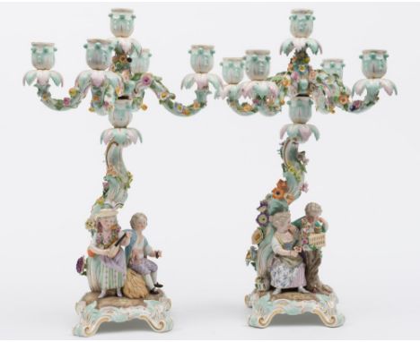 A pair of Meissen porcelain figural five-light candelabra: emblematic of the seasons Spring and Autumn after models by J.C.Sc