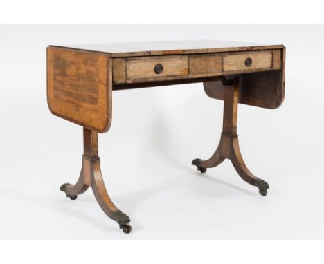 A mahogany, amboyna wood and inlaid sofa table in the Regency taste:, bordered with boxwood lines, the crossbanded hinged top