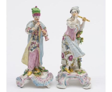 A pair of French figures of Turkish musicians in the Bow style: both wearing light blue, pink and yellow floral decorated cos