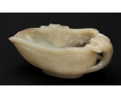 A Chinese carved jade libation cup: of tapering oviform the exterior and handle carved as Chilong beneath a thunder key band,