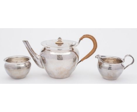 A George V silver three-piece tea service, maker Keswick School of Industrial Art, Chester, 1915/16:, of ovoid hammered form,