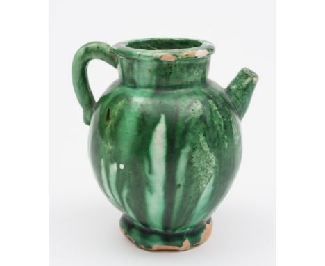 A Chinese small green-glazed pottery ewer: of ovoid form with short upturned spout and loop handle, Tang Dynasty,11 cm [some 