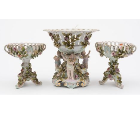 A Sitzendorf porcelain centrepiece and a pair of Dresden pedestal baskets: the centrepiece in the form of a pierced basket ap