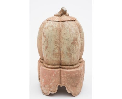 A Chinese pottery melon form jar and cover: in Han Dynasty style, on integral stand with ruyi shaped feet, 29 cm.