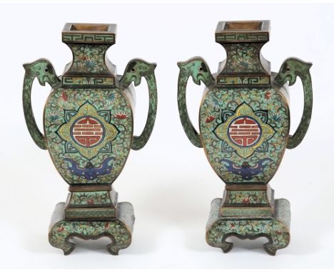A pair of Chinese cloisonne two-handled vases: each of baluster square section, decorated with shou medallions and bats on a 