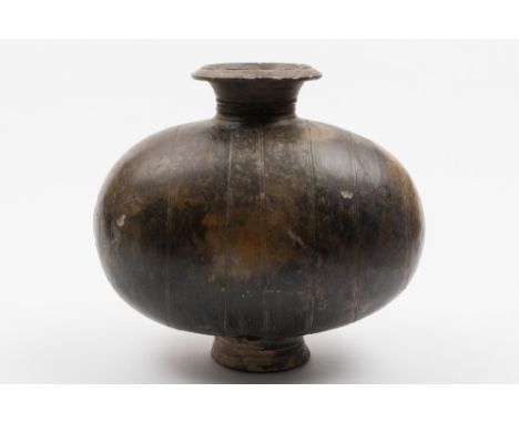 A Chinese pottery cocoon vase: with flaring neck and footrim, the ovoid body incised with concentric reeded bands, Han Dynast