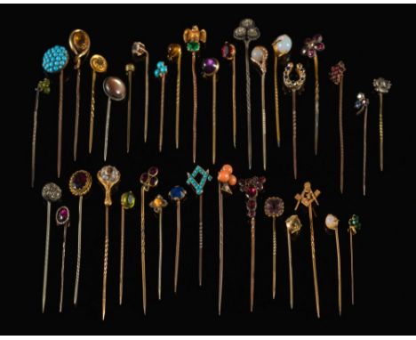 A collection of 36 gold, gilt metal and gem-set stick-pins to include: a rose-cut sapphire single-stone stick-pin, a coral mo