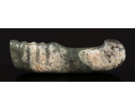 A Chinese jade handle: with ridged grip and two fitting holes, the stone of mottled dark green colour with grey calcification