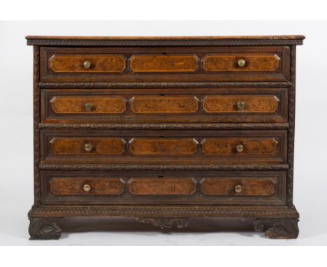 An early 18th Century Lombardy walnut, carved and pokerwork decorated rectangular chest:, the top with a moulded edge and flu