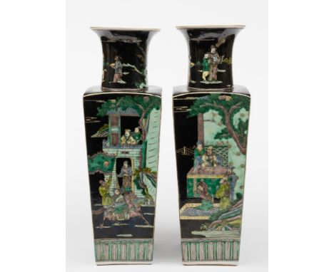 A pair of Chinese porcelain famille noire vases: of shouldered square form with raised flaring neck, each facet decorated in 