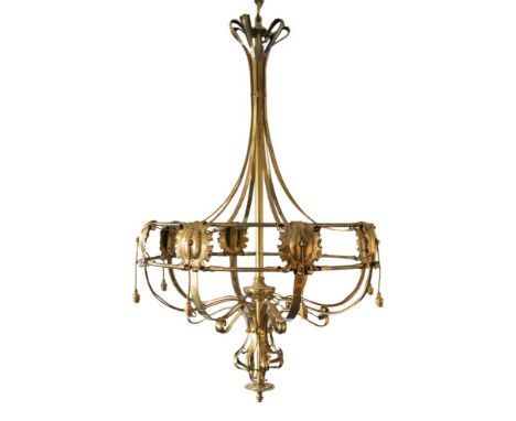 A large Arts and Crafts influence brass eight-light electrolier: the scrolled and swept stem linking a rope twist and foliate