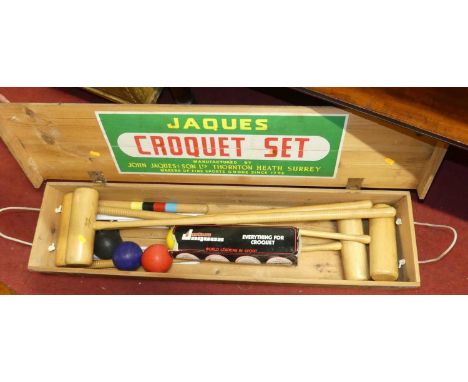 A Jaques croquet set in fitted pine boxMallets with knocks from use.Paint chips and wear to hoops.Exterior of box a bit tired
