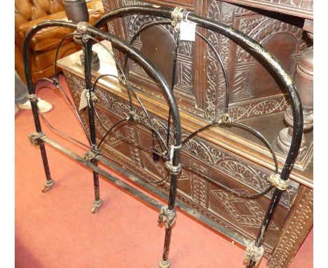 A late Victorian wrought iron single bedstead (lacking side rails)