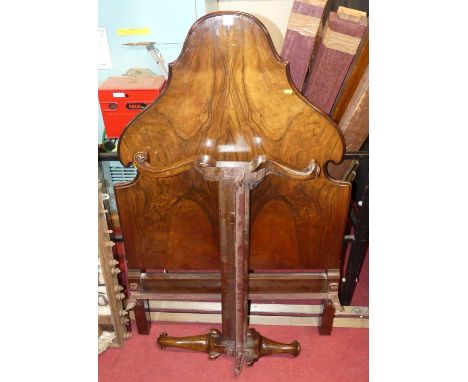 An early 20th century figured walnut single bedstead, having iron side rails