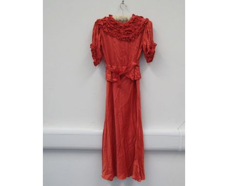 A late 1930's early 40's burnt orange silk full length evening dress with ruching detail at neckline and sleeve peplum waist 