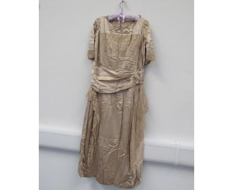 A 1910-20 oyster silk evening dress hand embroidered lace detail, loosely gathered ruched drop waist with button detail