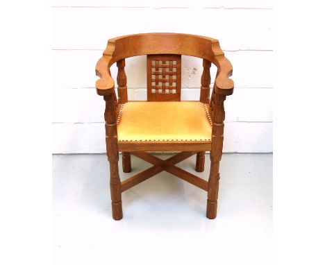 Mouseman, (Robert Thompson), oak armchair curved back, carved lattice panels, and tan leather seat on octagonal baluster legs