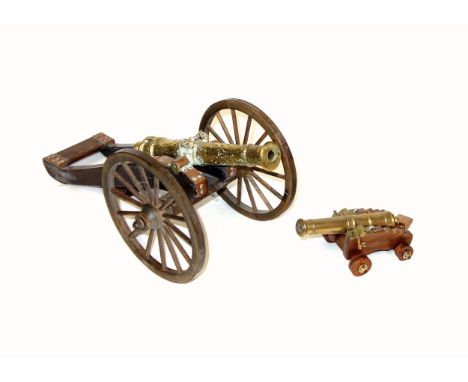 Model of a brass 1647 cannon on a stained wood carriage with metal bound wheels, L.44cm, length of barrel 26cm overall, bore 