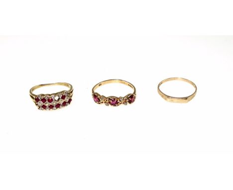 9ct gold ruby and diamond ring, three rubies and four diamonds in a pierced scrolling mount, size Q 1/2, 1.8 grams, yellow me