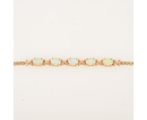 An opal and diamond bracelet, five oval cabochon cut opals 7mm x 5mm, individually claw set and space by six small diamonds, 