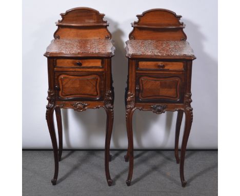 Pair of French walnut and rosewood bedside cabinets, with marble tops, each with a raised back and serpentine shelf, fitted w