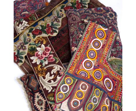 FOUR MIDDLE EASTERN RUG COVERED CUSHIONS the largest 56cm x 85cm together with a tapestry cushion cover, Indian mirrored fabr