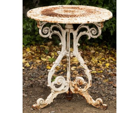 A WHITE PAINTED CAST IRON GARDEN TABLE with circular pierced top, on a scroll decorated tripod base, 61cm diameter x 67cm hig