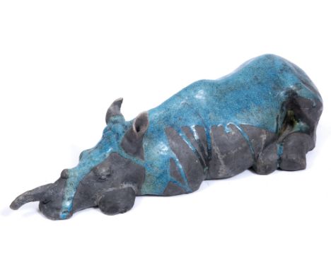 CHRISTINE HALL (LATE 20TH / EARLY 21ST CENTURY ENGLISH SCHOOL) 'Resting Rhinoceros', turquoise raku glazed ceramic, 52cm long