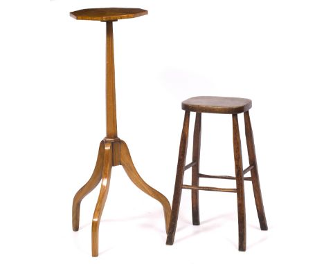 A SATINWOOD TORCHERE with octagonal top, conforming column support and on a tripod base 27.8cm diameter x 89.5cm high togethe