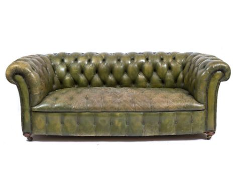 A GREEN LEATHER UPHOLSTERED CHESTERFIELD SETTEE with turned bun feet and ceramic casters, 206cm wide x 86cm deep x 77cm high