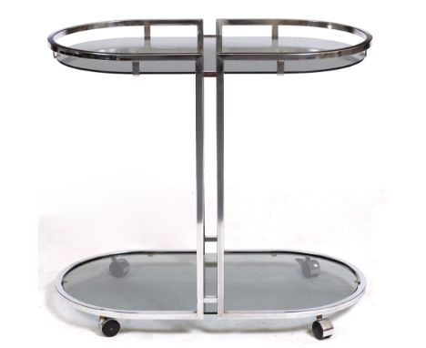 A MID TO LATE 20TH CENTURY CHROME AND GLASS ART DECO STYLE DRINKS TROLLEY with rounded ends and on casters, 77.5cm x 43.5cm x