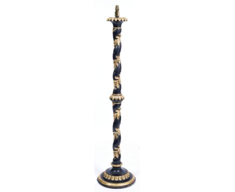 AN EBONISED AND PARCEL GILT LAMP STANDARD with barley twist column and circular spreading base, 148cm high overall including 