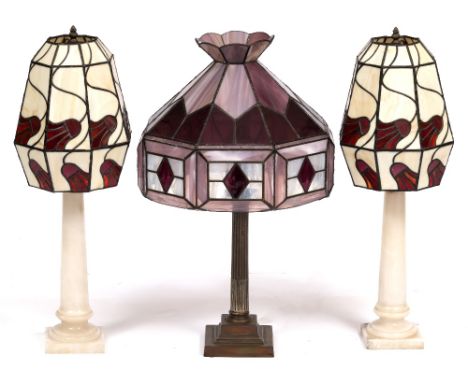 A PAIR OF TURNED ALABASTER TABLE LAMPS of column form with leaded coloured glass shades 70cm high together with a further tab