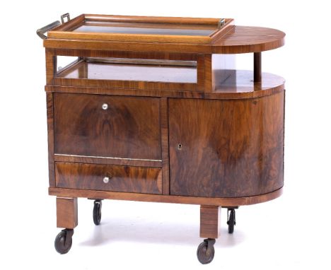 AN ART DECO WALNUT DRINKS TROLLEY c.1930 with glass inset detachable tray to the top, one rounded end and with compartments a