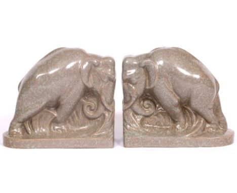 A PAIR OF POOLE POTTERY ELEPHANT BOOKENDS each with impressed marks beneath 19cm long x 16.5cm high (2)