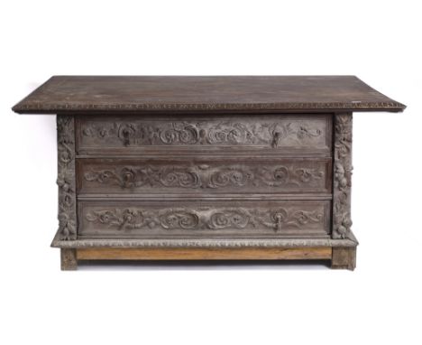 A 19TH CENTURY CONTINENTAL OAK DOUBLE SIDED COMMODE with carved decoration to both sides of the three long drawers, each deco
